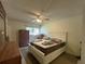 Well-lit main bedroom with a ceiling fan, white trim and a neutral color scheme at 7939 Pine Dr # 7939, Temple Terrace, FL 33637