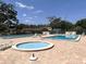 Community pools with lounge chairs at 7939 Pine Dr # 7939, Temple Terrace, FL 33637