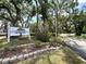 Entrance sign to Meadowood neighborhood, surrounded by trees and landscaping at 7939 Pine Dr # 7939, Temple Terrace, FL 33637