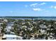 Beautiful aerial view of homes near a serene waterfront under a partly cloudy sky at 880 Mandalay Ave # N1004, Clearwater Beach, FL 33767
