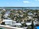 Scenic aerial view of homes and palm trees near the water on a sunny day at 880 Mandalay Ave # N1004, Clearwater Beach, FL 33767