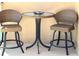 Cozy balcony seating featuring two wicker chairs and a glass-topped table for relaxing outdoors at 880 Mandalay Ave # N1004, Clearwater Beach, FL 33767