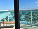Balcony with a chair that provides a fantastic view of the beach, ocean, and neighborhood at 880 Mandalay Ave # N1004, Clearwater Beach, FL 33767