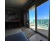 Living room with large sliding glass doors that lead to a balcony overlooking the beach and ocean views at 880 Mandalay Ave # N1004, Clearwater Beach, FL 33767