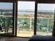Balcony with seating overlooking the bay, surrounding neighborhoods, and lush tropical landscaping at 880 Mandalay Ave # N1004, Clearwater Beach, FL 33767