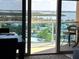 Balcony with seating that overlooks the ocean, bay, and neighborhood landscape at 880 Mandalay Ave # N1004, Clearwater Beach, FL 33767