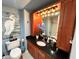 Stylish bathroom featuring wood cabinets, granite countertop, and a coordinated vanity mirror at 880 Mandalay Ave # N1004, Clearwater Beach, FL 33767