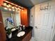 Bathroom with wood cabinets, a granite countertop, and stylish nautical decor at 880 Mandalay Ave # N1004, Clearwater Beach, FL 33767