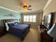 This bedroom features a ceiling fan, shuttered windows and a blue and tan color scheme at 880 Mandalay Ave # N1004, Clearwater Beach, FL 33767