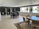 Community room features tables, chairs, and ocean views at 880 Mandalay Ave # N1004, Clearwater Beach, FL 33767