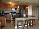 Kitchen with stainless appliances, bar seating, and black countertops at 880 Mandalay Ave # N1004, Clearwater Beach, FL 33767