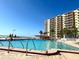 Bright community pool with plenty of space for tanning and swimming near the beach and community building at 880 Mandalay Ave # N1004, Clearwater Beach, FL 33767