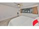 Bright bedroom featuring soft carpet, ceiling fan, and large window at 880 S Village N Dr # 202, St Petersburg, FL 33716