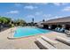 Community pool with crystal-clear water and plenty of lounge chairs for relaxation at 880 S Village N Dr # 202, St Petersburg, FL 33716