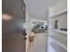 Bright condo entrance featuring light floors leading to a spacious living area with shelves at 880 S Village N Dr # 202, St Petersburg, FL 33716