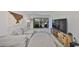 Spacious living area with a large sofa, entertainment center, and a view of the balcony at 880 S Village N Dr # 202, St Petersburg, FL 33716