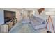 Open-concept living room showcases stylish furnishings, natural light, and access to other areas at 880 S Village N Dr # 202, St Petersburg, FL 33716