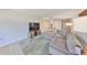 Condo living room featuring an open layout, comfortable sofa, and seamless flow to other spaces at 880 S Village N Dr # 202, St Petersburg, FL 33716