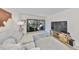 Bright living room with sliding glass doors to the balcony, couch, TV and decorative rug at 880 S Village N Dr # 202, St Petersburg, FL 33716