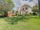 Backyard with mature landscaping and a deck alongside a screened-in pool, providing a private retreat at 8907 Magnolia Chase Cirs, Tampa, FL 33647