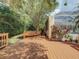 Backyard deck near a screened-in pool area offers a tranquil space to unwind and entertain at 8907 Magnolia Chase Cirs, Tampa, FL 33647