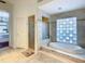 Spacious bathroom featuring a soaking tub, a glass shower, and a doorway to the bedroom at 8907 Magnolia Chase Cirs, Tampa, FL 33647