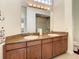 Bathroom with a double sink vanity, granite countertop, and a glass shower at 8907 Magnolia Chase Cirs, Tampa, FL 33647