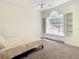 Bedroom featuring a window with built-in shelves and cabinets around it at 8907 Magnolia Chase Cirs, Tampa, FL 33647