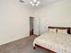Cozy bedroom featuring a bed and doorway leading to another room at 8907 Magnolia Chase Cirs, Tampa, FL 33647