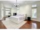Spacious bedroom features hardwood floors, a floral bedspread, and large windows that let in plenty of natural light at 8907 Magnolia Chase Cirs, Tampa, FL 33647