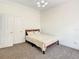 Bedroom with neutral carpet, bed with patterned bedding, and a double door closet at 8907 Magnolia Chase Cirs, Tampa, FL 33647