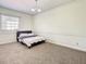 Cozy bedroom featuring neutral carpet, crown molding and a window at 8907 Magnolia Chase Cirs, Tampa, FL 33647