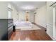 Spacious bedroom featuring hardwood floors, a floral bedspread, and a chest of drawers at 8907 Magnolia Chase Cirs, Tampa, FL 33647