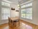 Bright dining area with large windows, natural light, and hardwood floors at 8907 Magnolia Chase Cirs, Tampa, FL 33647