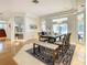 Spacious dining room with a modern table, seating for six, and an adjacent living area for seamless entertaining at 8907 Magnolia Chase Cirs, Tampa, FL 33647
