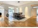 Sunlit dining area with hardwood floors and view of the enclosed pool area at 8907 Magnolia Chase Cirs, Tampa, FL 33647