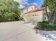 Two-story home with a red tile roof, a two car garage, and a light colored driveway at 8907 Magnolia Chase Cirs, Tampa, FL 33647
