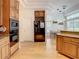 Open concept kitchen boasts stainless appliances, wood cabinetry, and adjoining dining area at 8907 Magnolia Chase Cirs, Tampa, FL 33647