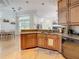 Bright open kitchen with granite countertops and wood cabinets, with an adjacent dining area at 8907 Magnolia Chase Cirs, Tampa, FL 33647
