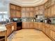 Spacious kitchen featuring wood cabinets, stone countertops, and stainless appliances at 8907 Magnolia Chase Cirs, Tampa, FL 33647