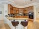 Modern kitchen with granite countertops, stainless steel appliances, and bar seating for casual dining and entertaining at 8907 Magnolia Chase Cirs, Tampa, FL 33647