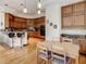 Spacious kitchen and breakfast nook featuring hardwood floors, wood cabinetry, and island seating at 8907 Magnolia Chase Cirs, Tampa, FL 33647