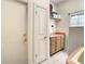 Laundry room with cabinets, shelving, window, and door leading to another room at 8907 Magnolia Chase Cirs, Tampa, FL 33647