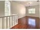 Spacious room with hardwood floors and a large arched window providing ample natural light at 8907 Magnolia Chase Cirs, Tampa, FL 33647