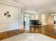 Bright living space featuring elegant columns, hardwood floors, with a view of a dining room and outdoor space at 8907 Magnolia Chase Cirs, Tampa, FL 33647