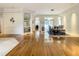 Open living space featuring hardwood floors, with a view of a dining room and outdoor space at 8907 Magnolia Chase Cirs, Tampa, FL 33647