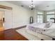 Bright main bedroom featuring hardwood floors, with access to ensuite bathroom at 8907 Magnolia Chase Cirs, Tampa, FL 33647