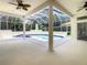 View of the lanai featuring a pool and spa with white patio at 8907 Magnolia Chase Cirs, Tampa, FL 33647