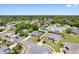 Wide aerial shot showcases a residential area with tree-lined streets and manicured lawns under a clear blue sky at 1061 Archway Dr, Spring Hill, FL 34608