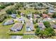 Aerial view of a neighborhood featuring homes with screened-in pools and tidy yards at 1061 Archway Dr, Spring Hill, FL 34608